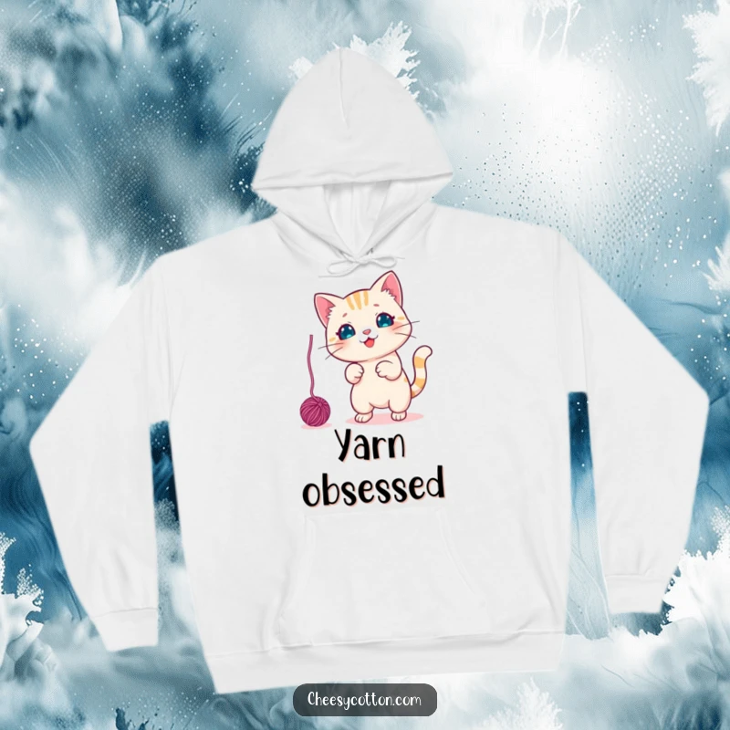 Funny Hoodie featuring a cute kawaii cat character playfully swatting a dangling yarn ball, designed for ultimate cozy fun.