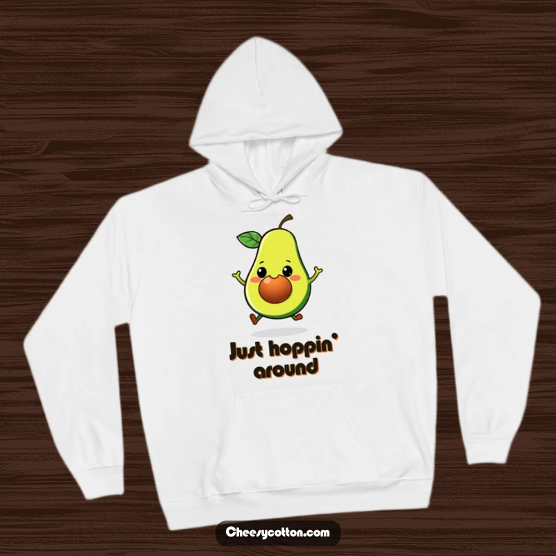 Funny Kawaii Avocado Hoodie: A big-grinned, hopping avocado illustration on a cozy sweatshirt, radiating playful vibes.