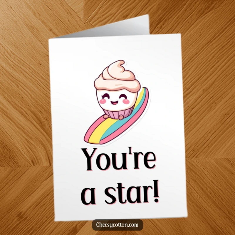 Funny free printable congratulations card: a smiling cupcake with mischievous eyes slides down a rainbow, celebrating.