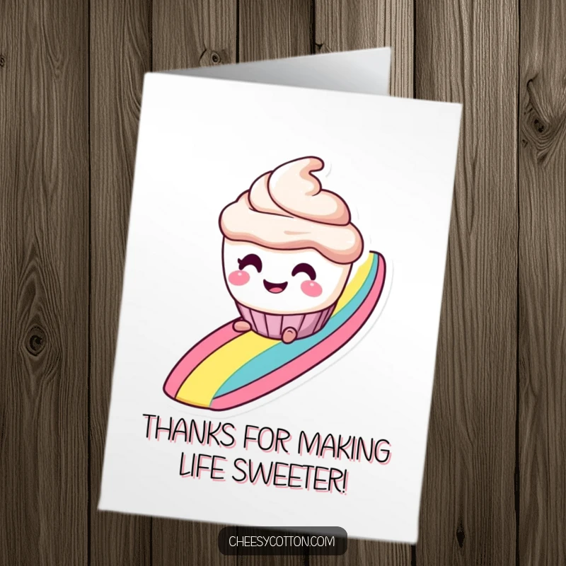 Funny free printable thank you card: a smiling cupcake character with mischievous eyes is sliding down a rainbow.