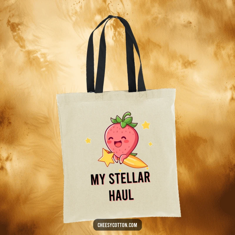 Funny tote bag with a cheerful strawberry character, excitedly riding a shooting star, perfect for carrying cosmic treasures.